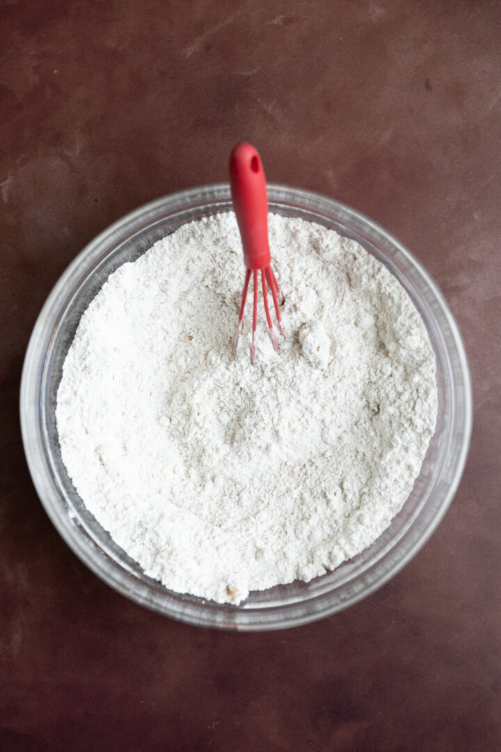 Dry ingredients for muffins in a glass bowl. 