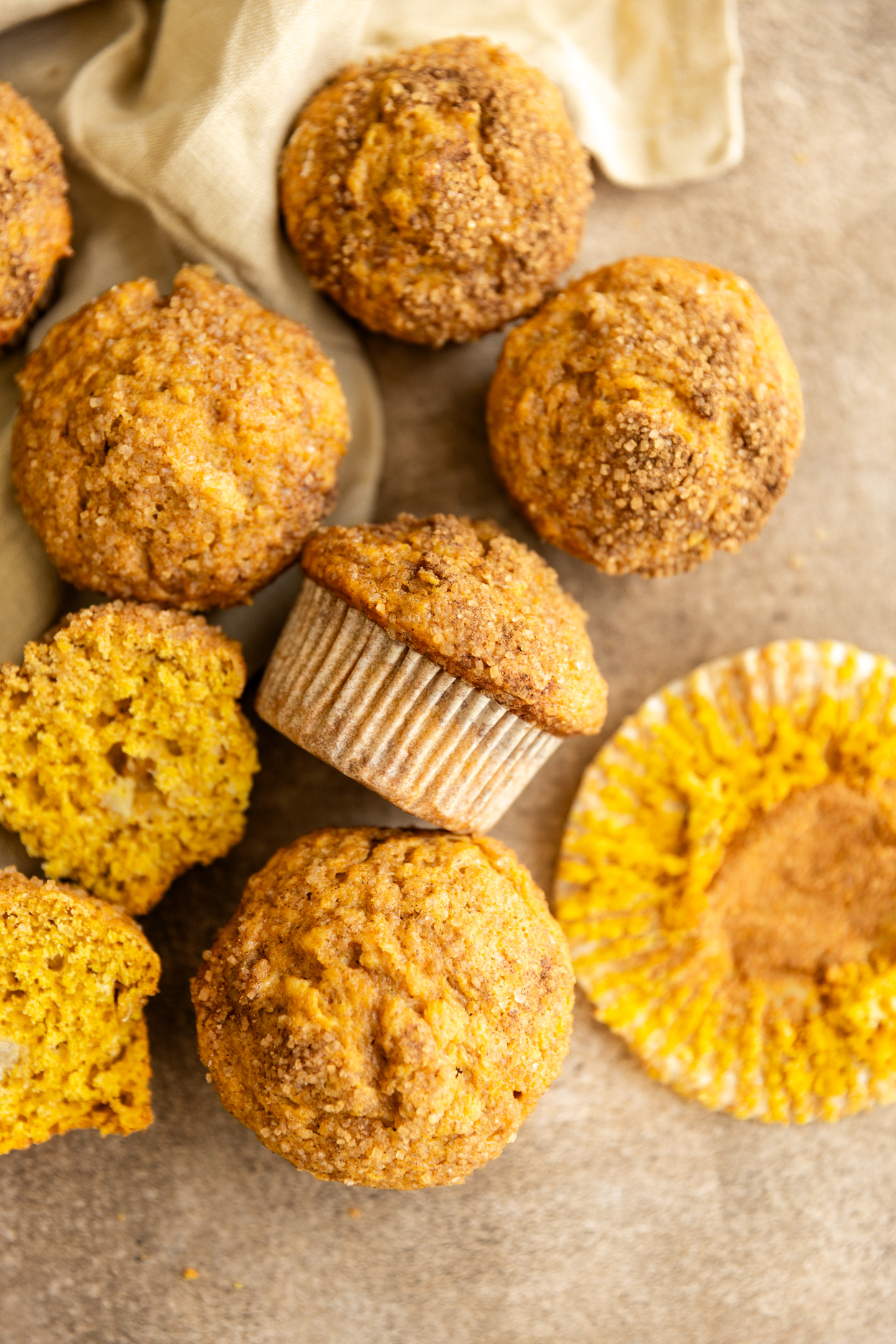 Pumpkin banana muffins on a brown surface. 