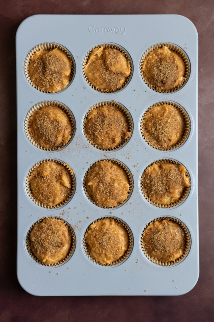 Pumpkin banana muffin batter in a muffin tin. 