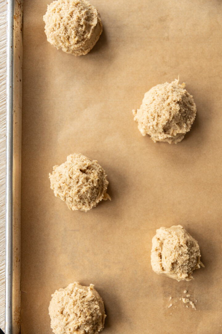 Cookie dough balls on a cookie sheet. 