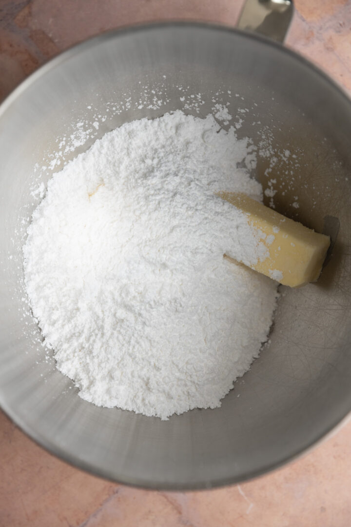Butter and powdered sugar in a mixing bowl. 