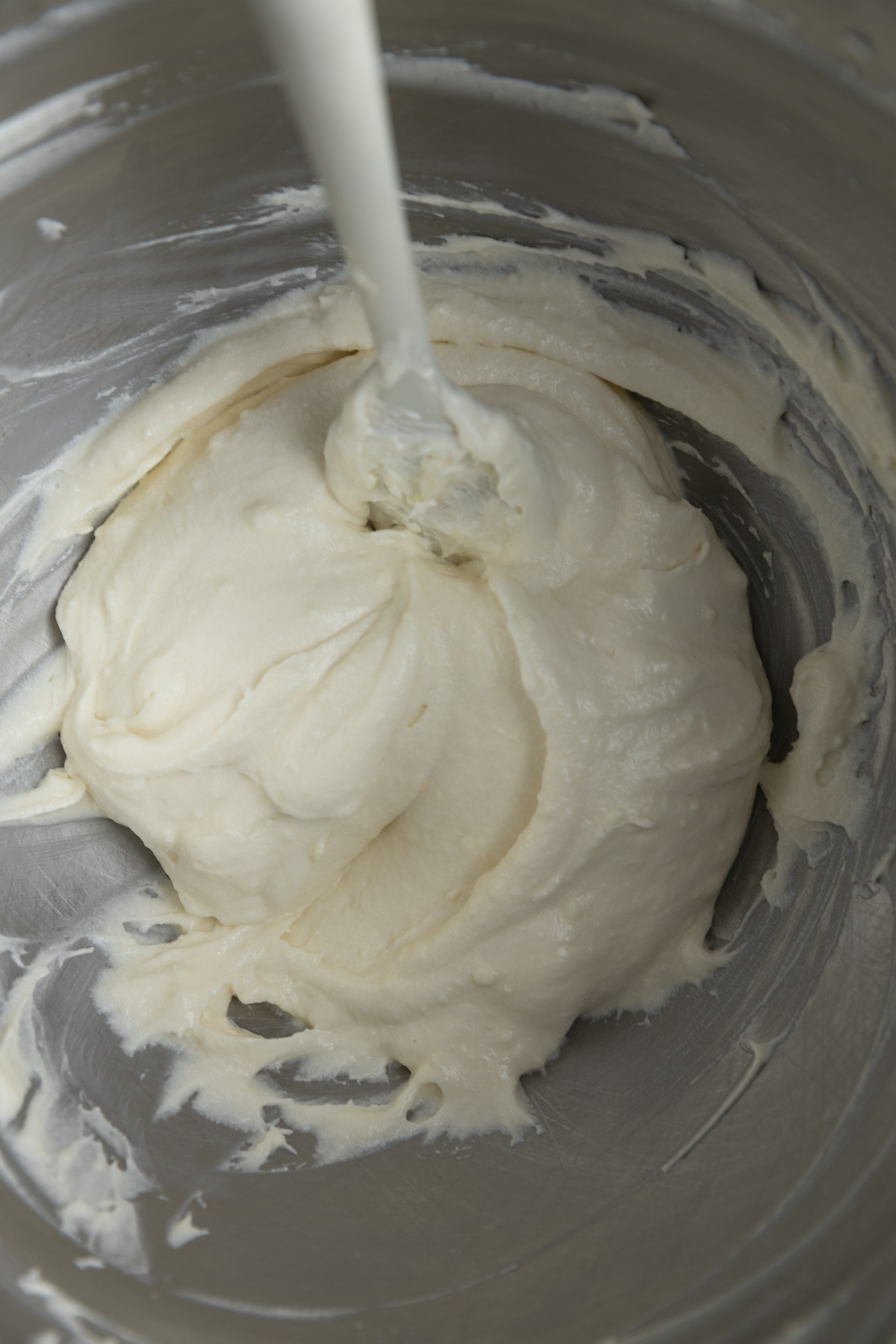 Cream cheese frosting in a mixing bowl.