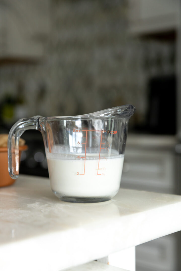 Heavy whipping cream in a measuring cup.