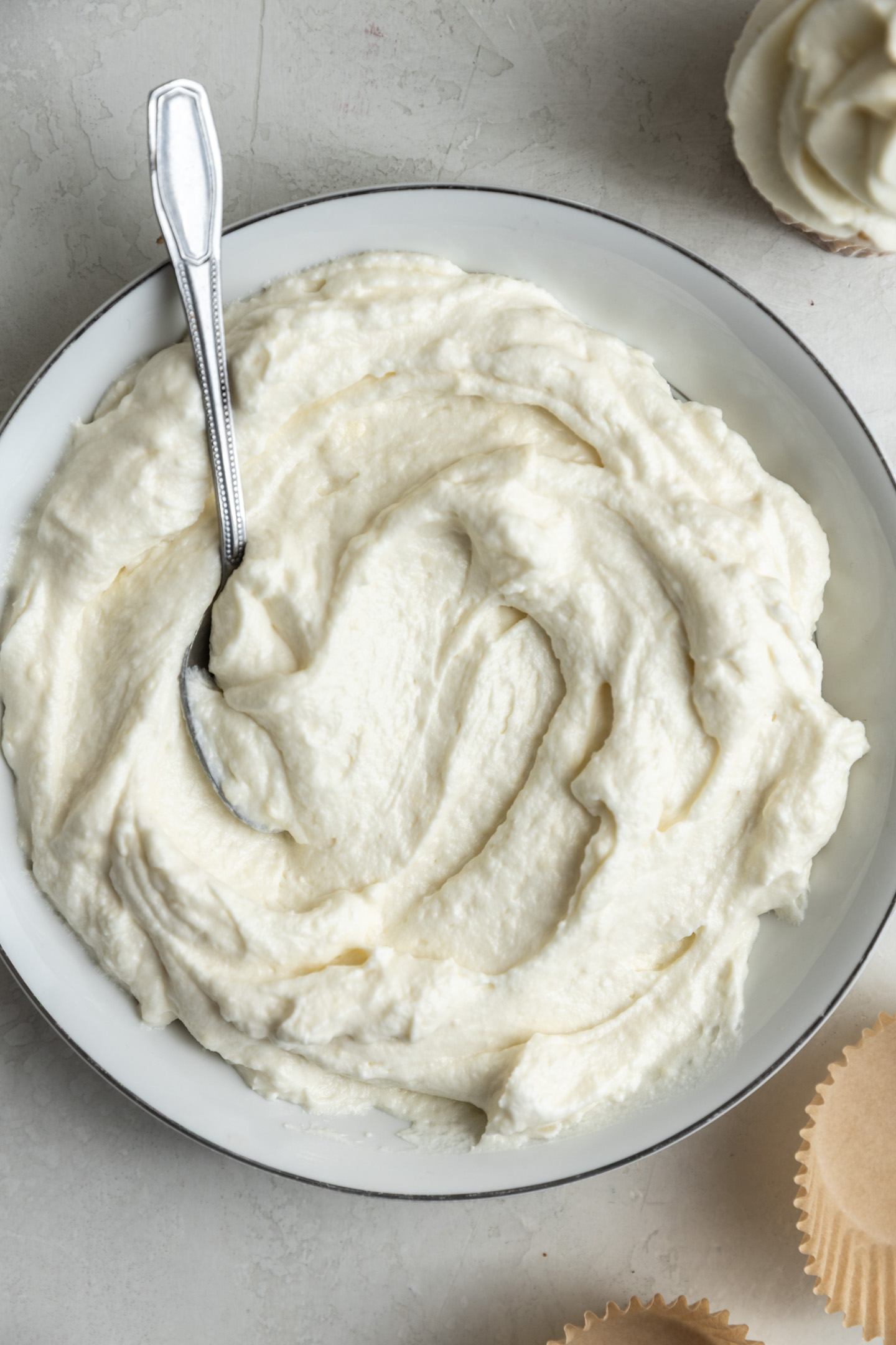 Cream cheese frosting without powdered sugar in a bowl.