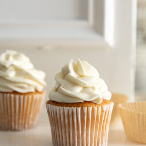 Cream cheese frosting without powdered sugar piped on a cupcake.