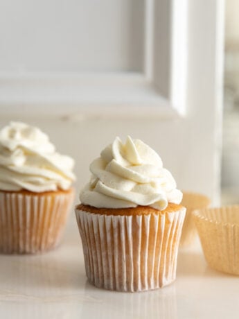 Cream cheese frosting without powdered sugar piped on a cupcake.