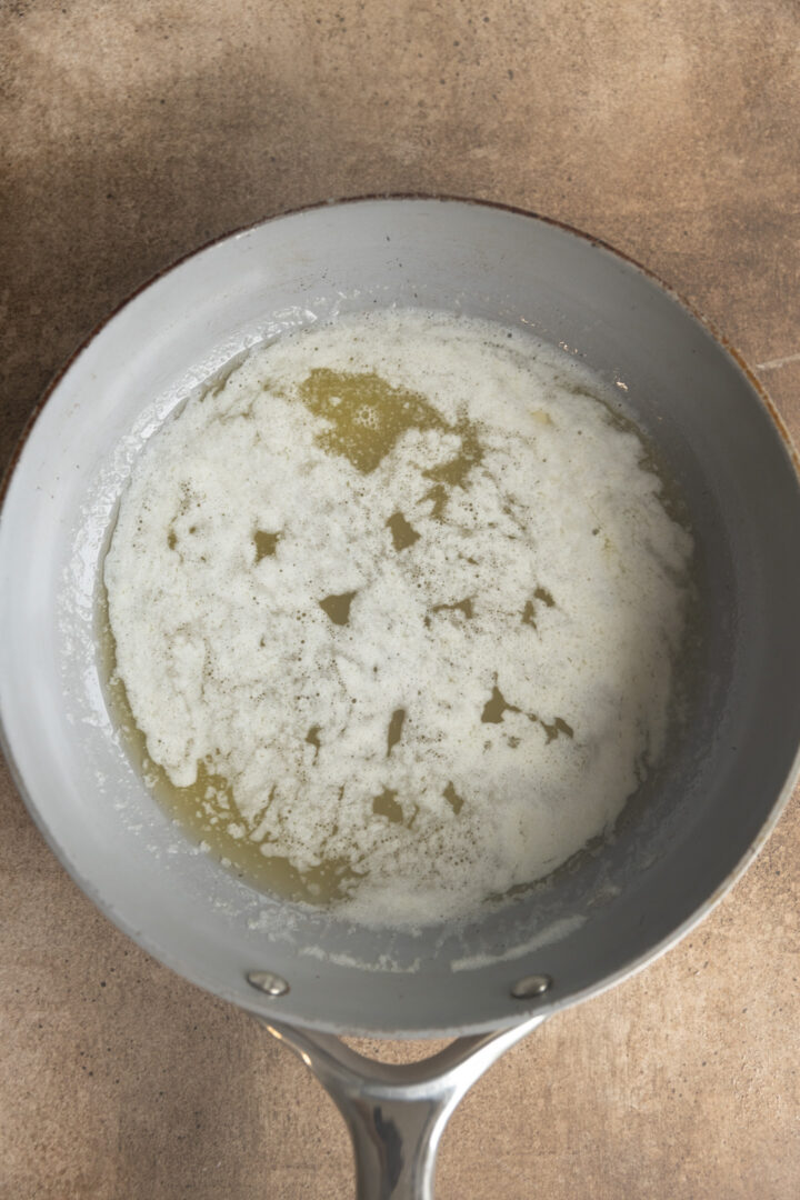 Melted butter foaming up in a saucepan. 