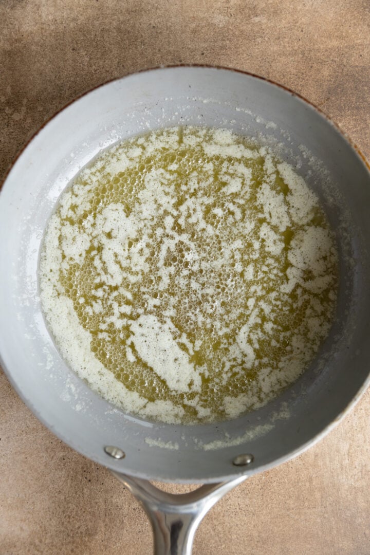 Yellow melted butter in a saucepan. 