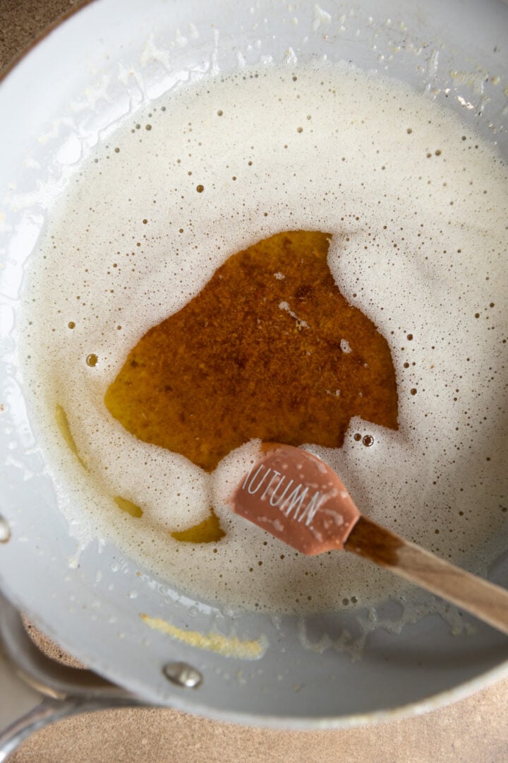 Browned butter in a saucepan with spatula.