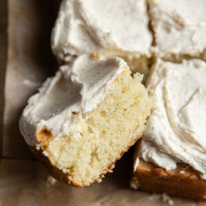 A square piece of a 9x13" cake laying on its side.