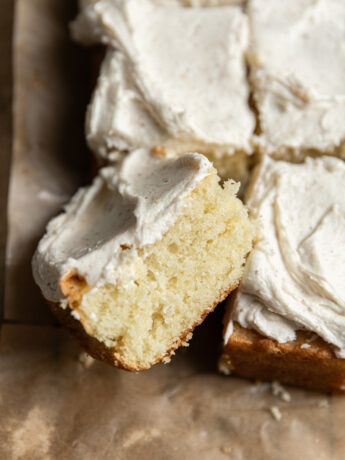 A square piece of a 9x13" cake laying on its side.