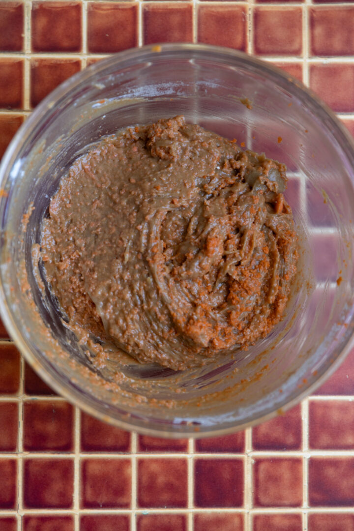 Carrot cake batter in a glass bowl.