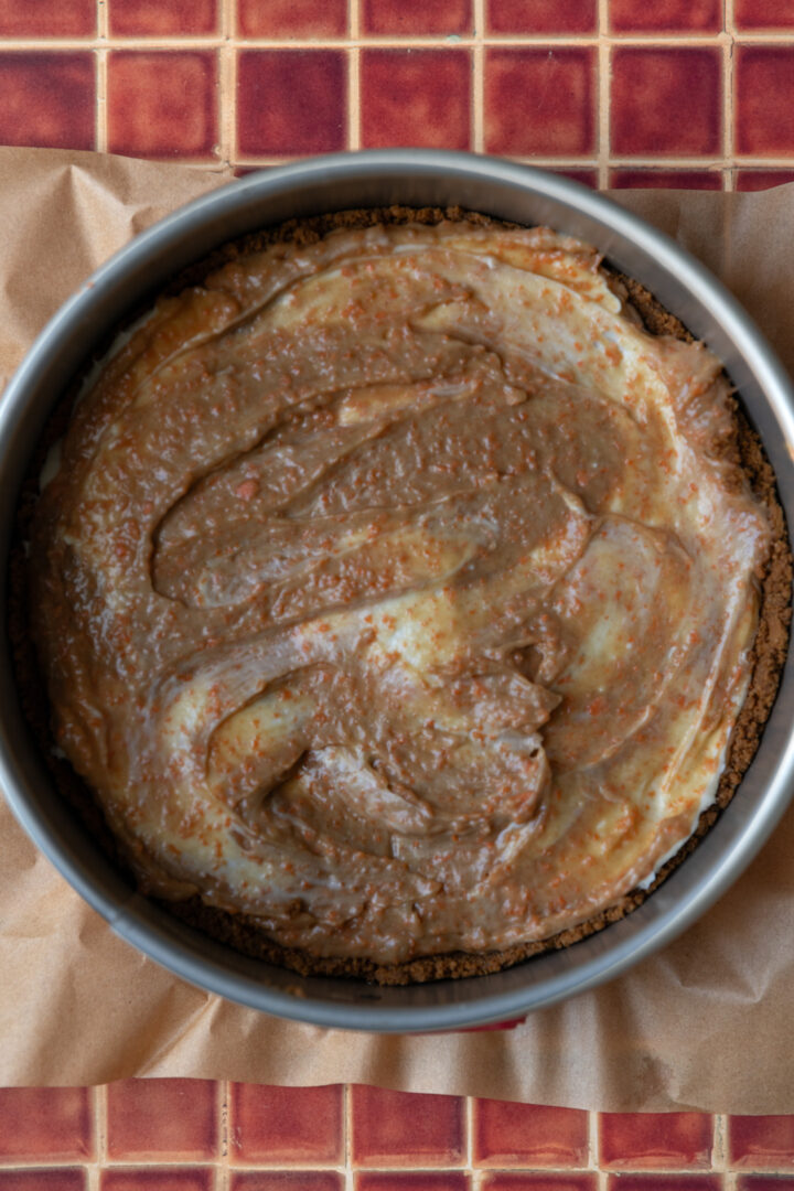 Carrot cake cheesecake batter in a springform pan.