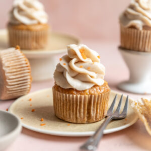 Carrot cake cupcakes frosted with cinnamon cream cheese frosting.