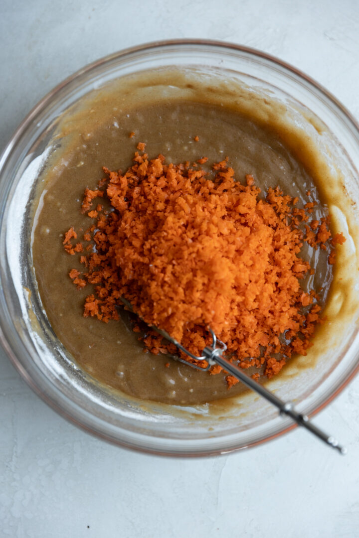 Carrot cake loaf batter in a glass bowl.