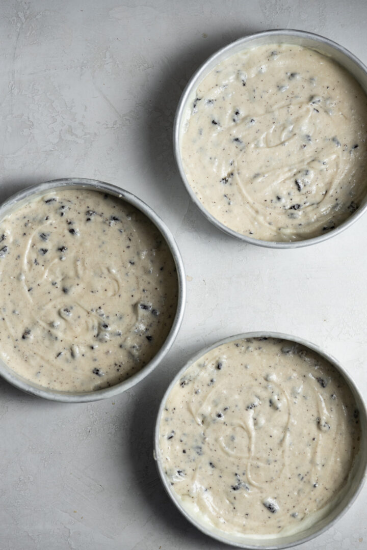 Cookies and cream batter in 3 cake pans.
