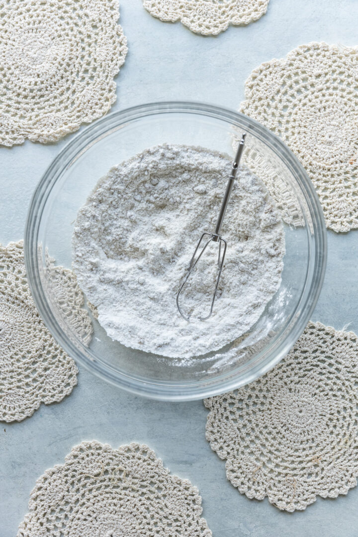 Dry ingredients for a cake in a glass bowl.