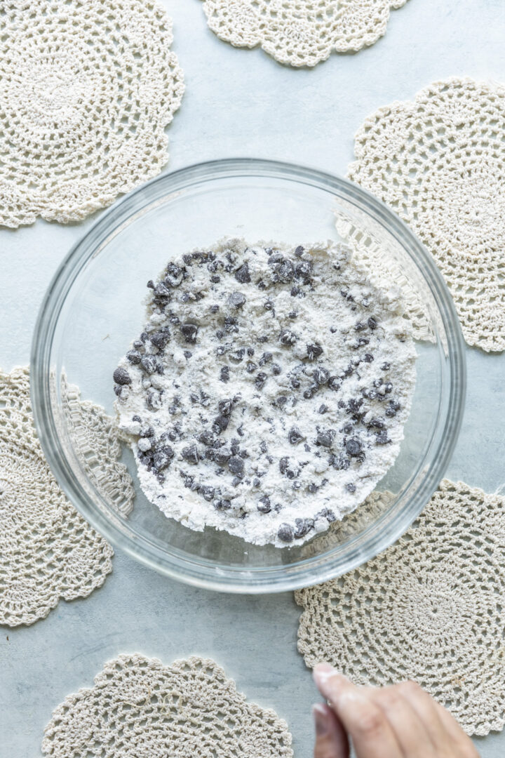 Chocolate chips and dry ingredients mixed together in a bowl.