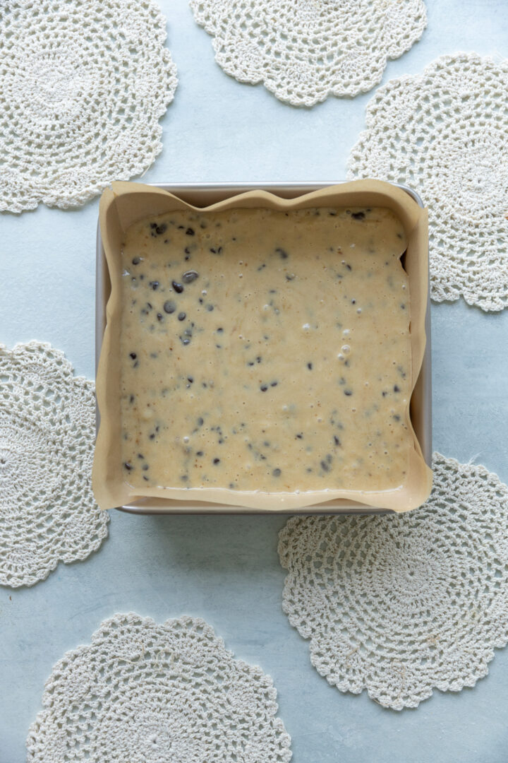 Cake batter poured into a 9x9 pan.