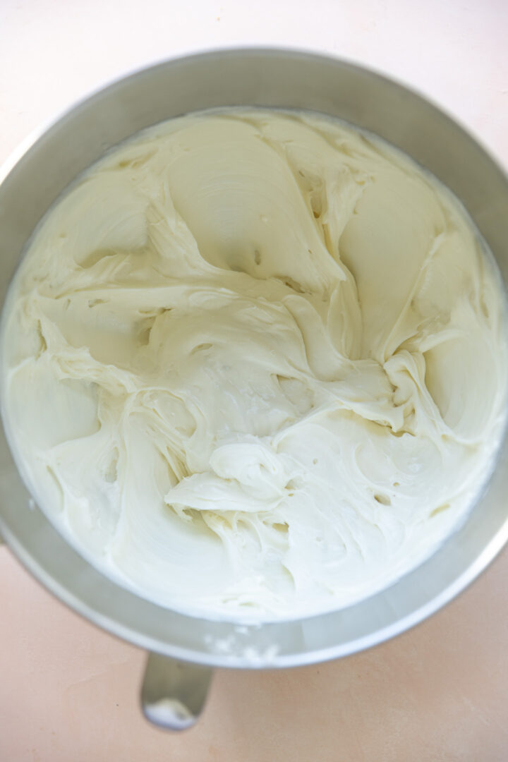 Cream cheese and granulated sugar creamed together in a mixing bowl.