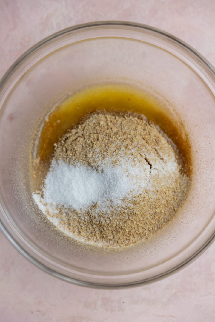 Melted butter, graham cracker crumbs and sugar in a glass bowl.
