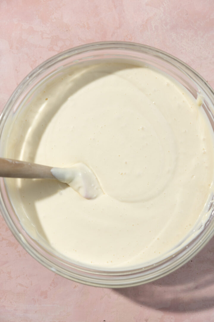 Cheesecake batter in a glass bowl.