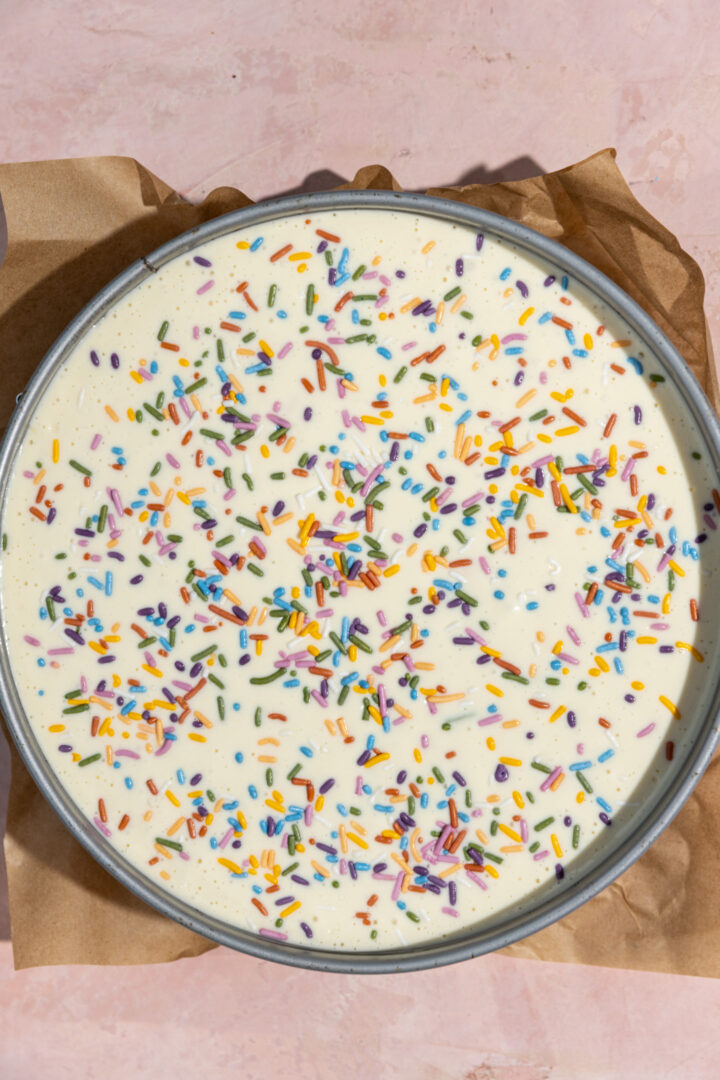 Birthday cake cheesecake batter in a springform pan.