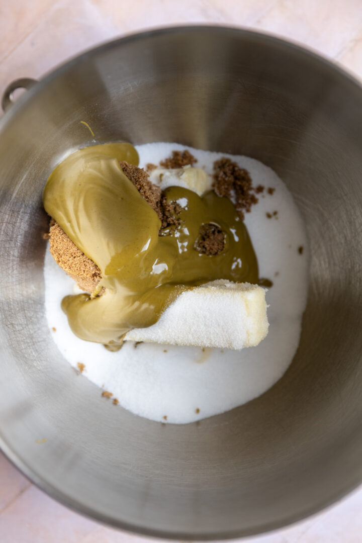Butter, sugar, brown sugar, and pistachio butter in a mixing bowl.
