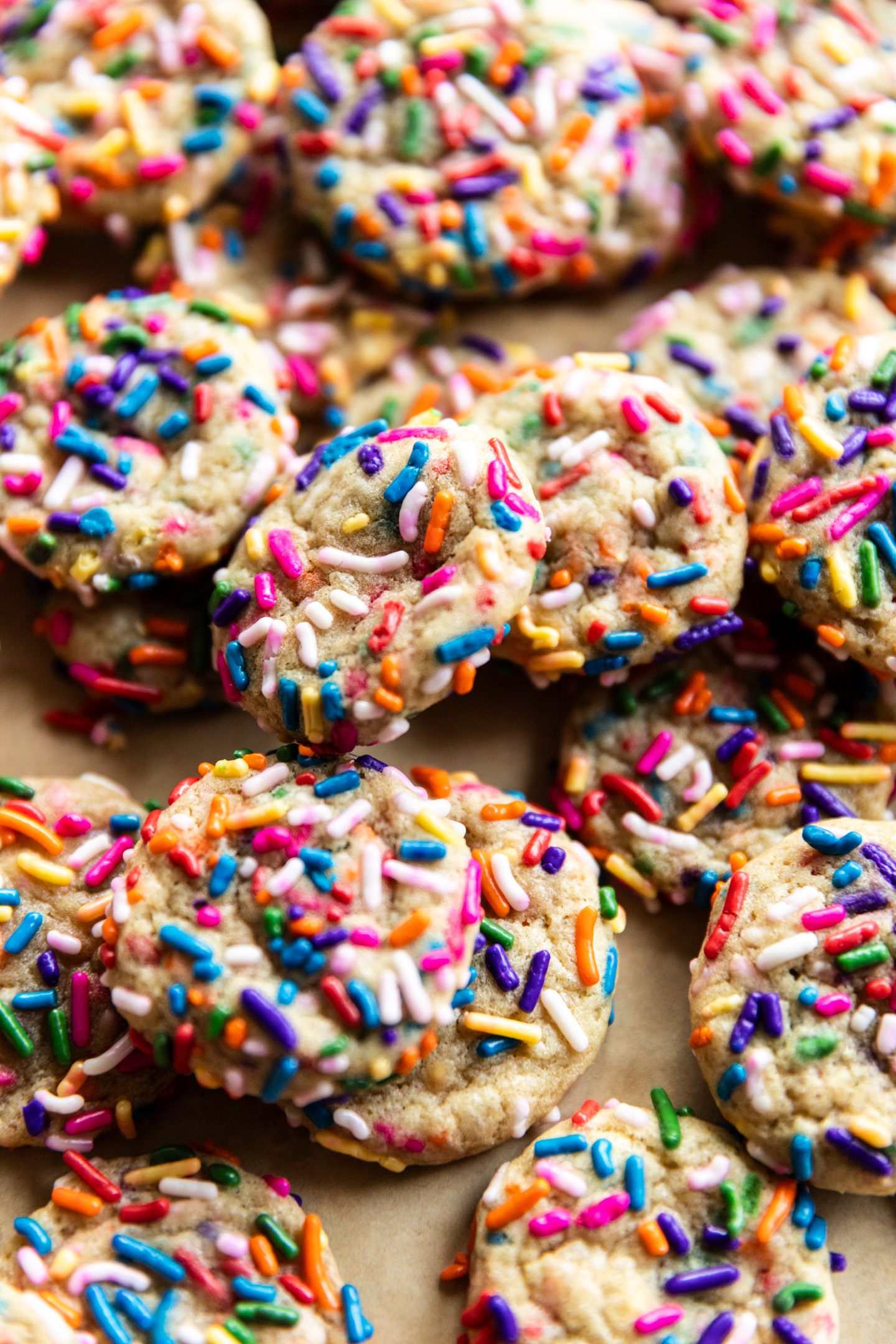 Mini sprinkle sugar cookies stacked on each other.