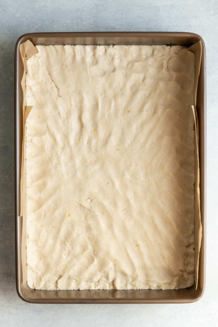 Lemon shortbread crust pressed into a 9x 13 pan