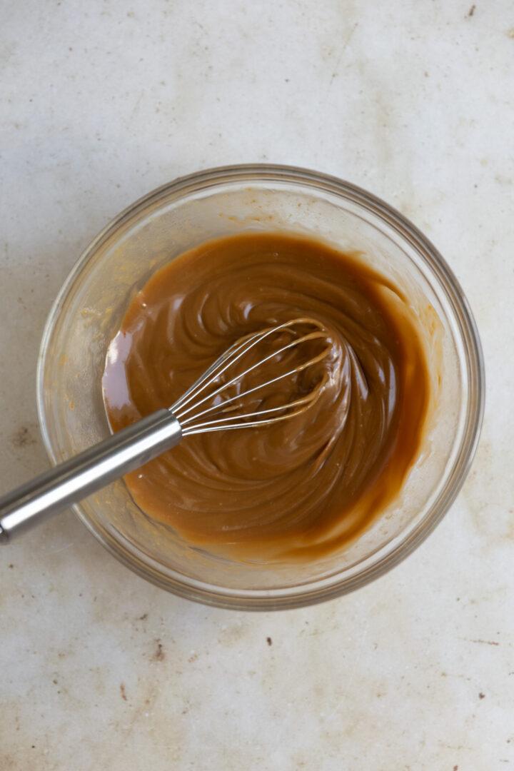 Cookie butter cookie mixture mixed in a glass bowl.